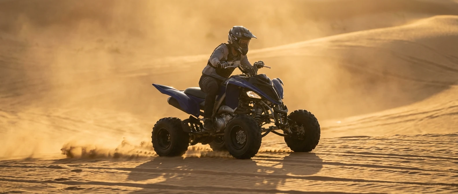 Dark sporty single seater quad bike in open Dubai desert