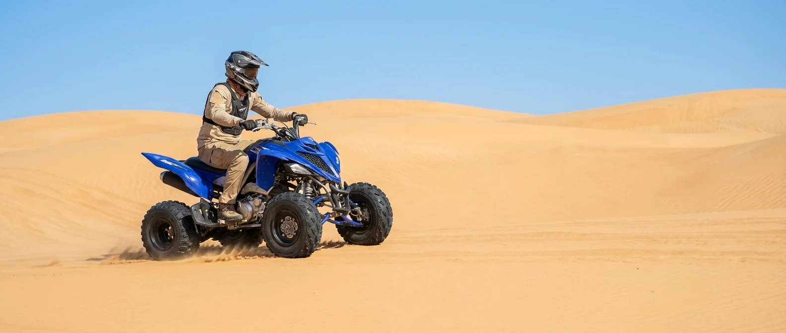 Blue Yamaha style quad bike in open Dubai desert
